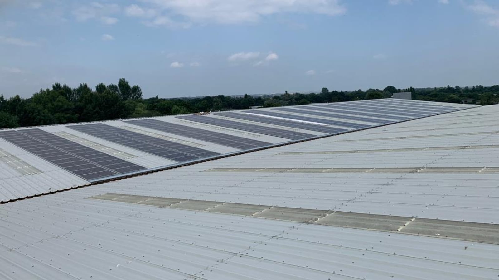 Wide view across the 175 kWp solar array on the Stiller warehouse roof