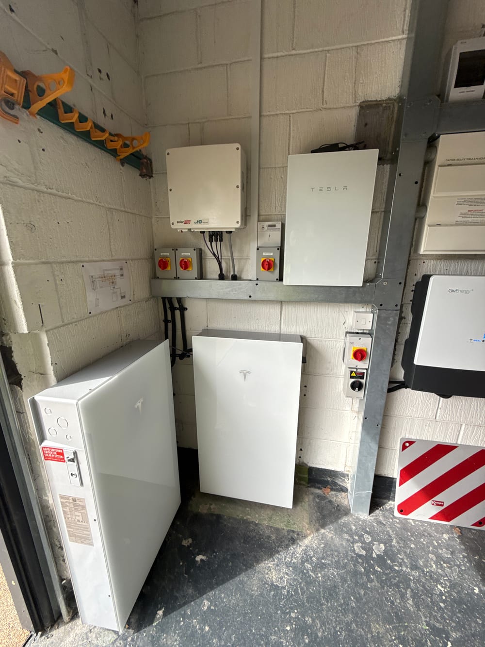 A Tesla Powerwall in a completed G Smith Electrical install, wired in alongside the inverter and isolation switchgear