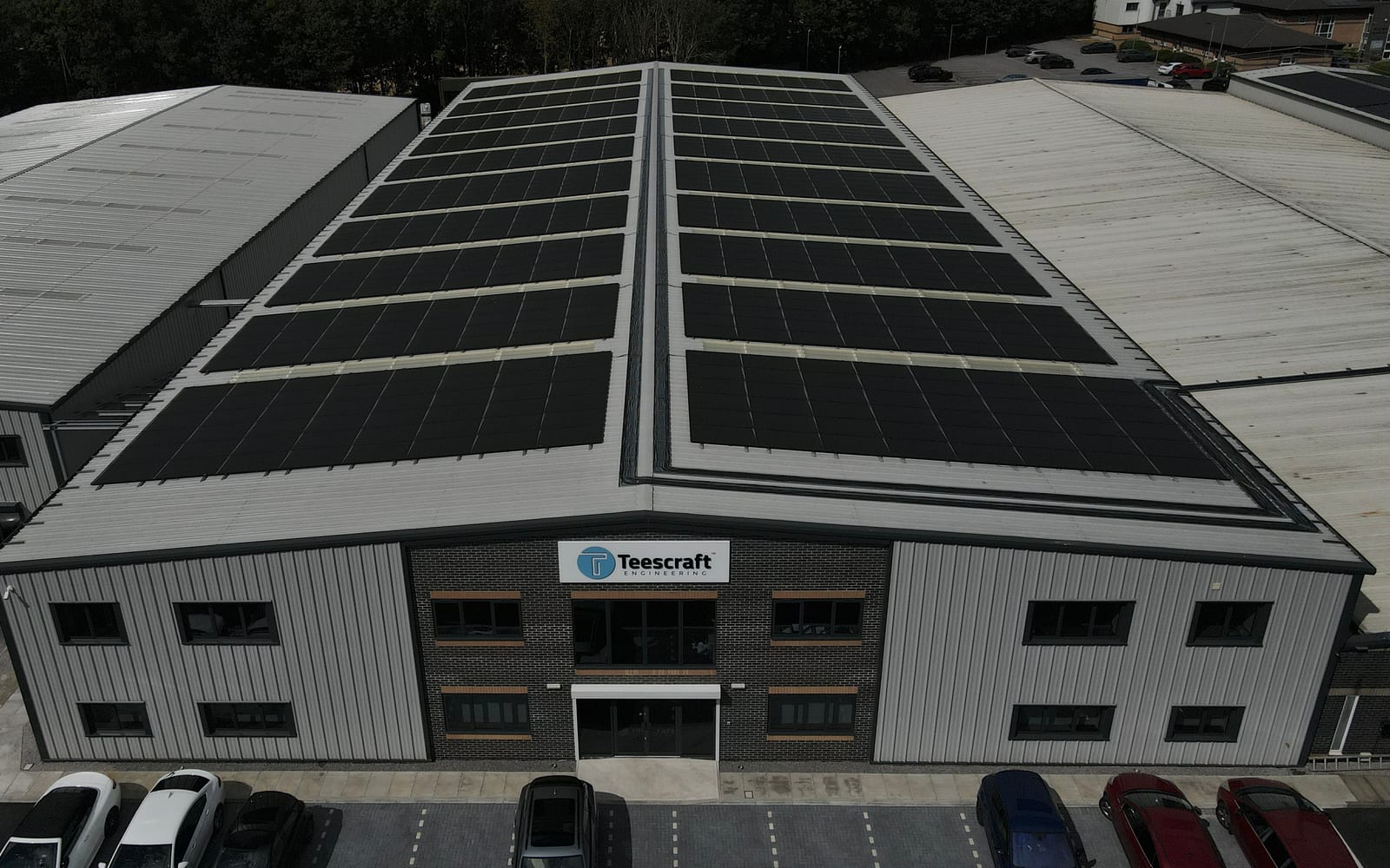 Completed commercial rooftop solar installation seen from the air