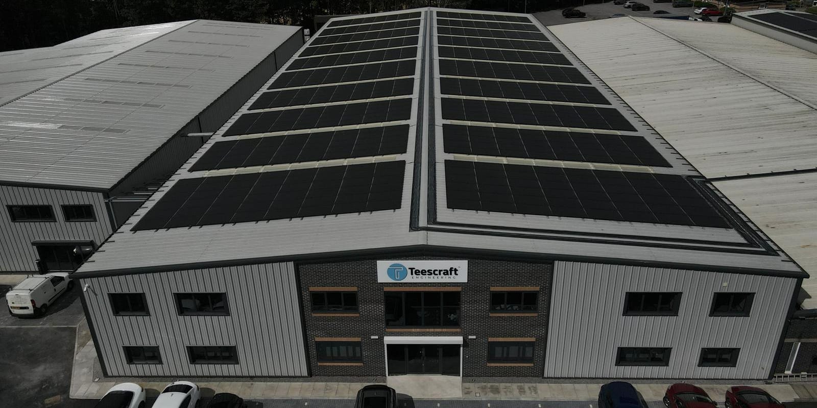 Aerial view of the Teescraft Engineering building with a large black rooftop solar array