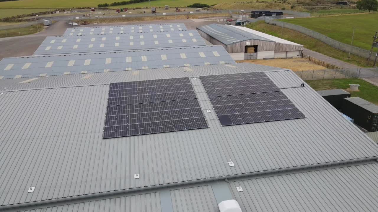 Aerial view of an agricultural shed with a rooftop solar array