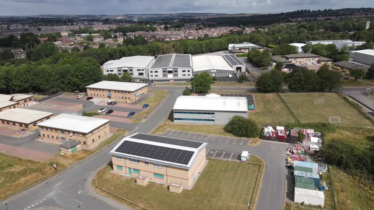 Aerial drone view of commercial units with rooftop solar arrays