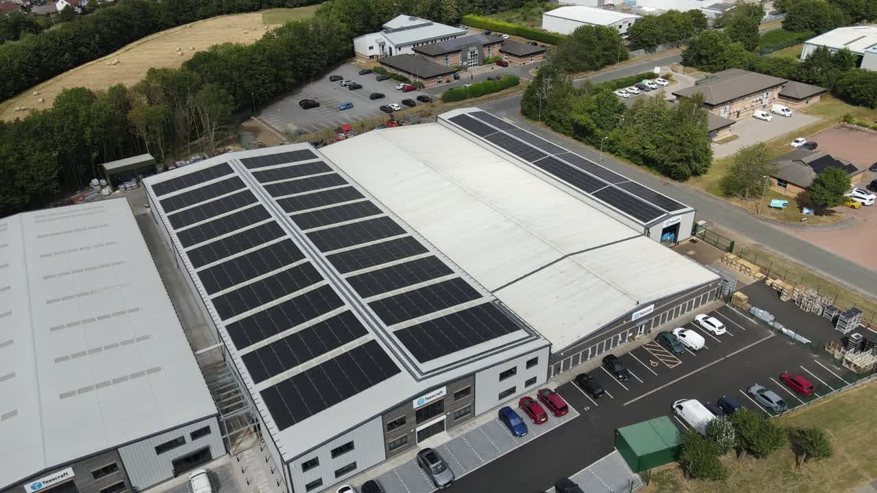 Aerial drone view of a solar array on a commercial warehouse roof