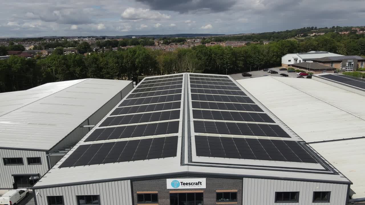 Aerial drone view of a solar array on a commercial warehouse roof