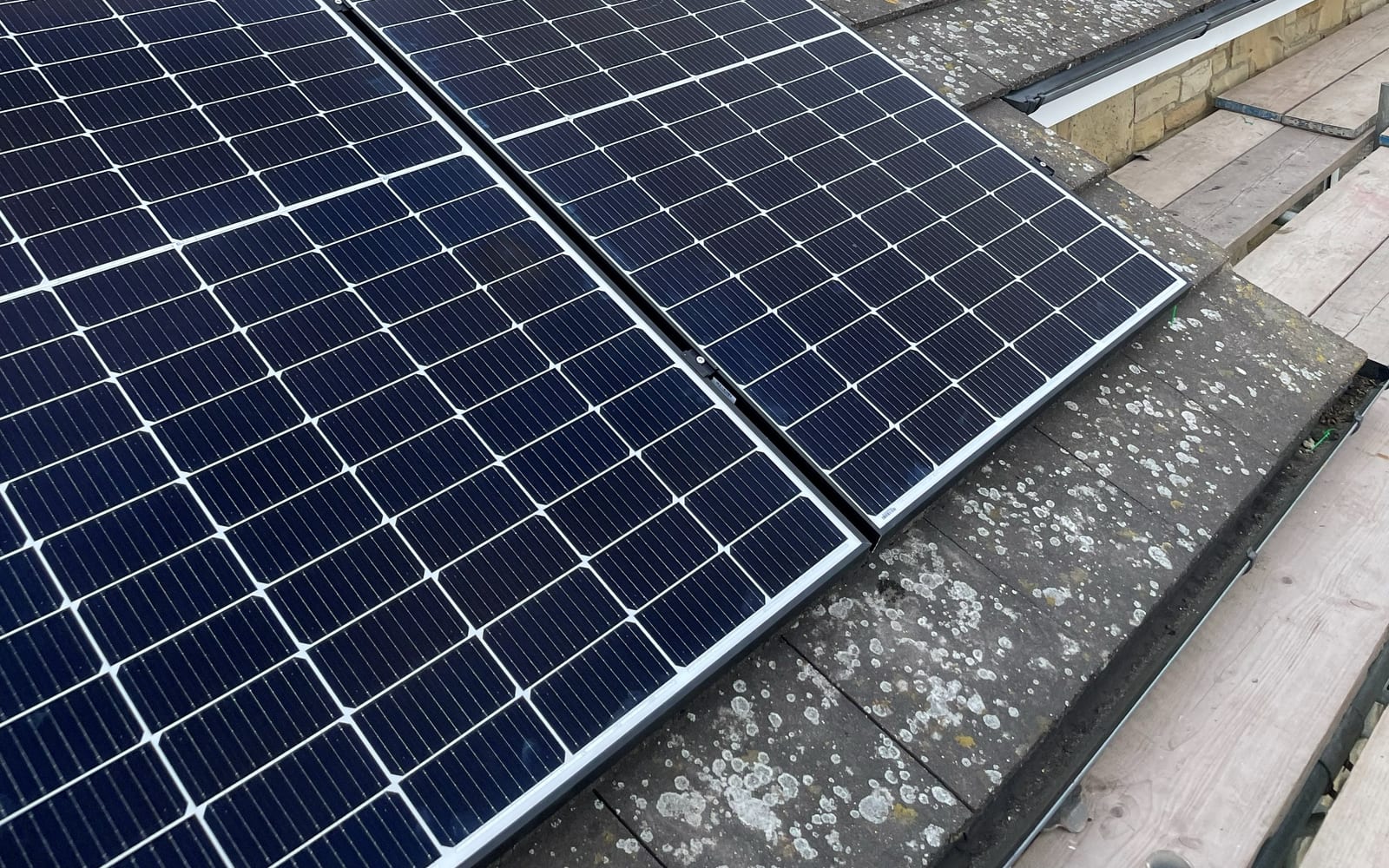 Close view of installed solar panels along a commercial roof edge