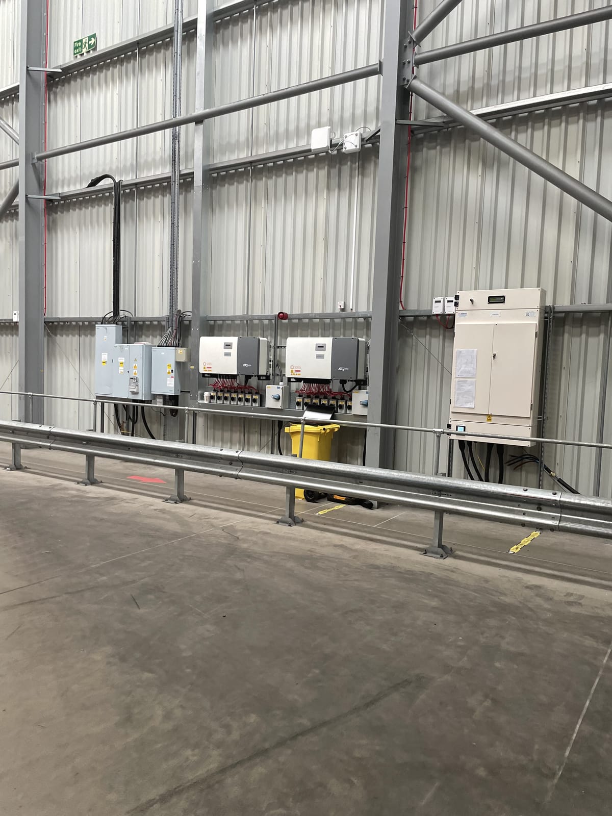 Solar inverters mounted on a commercial plant-room wall