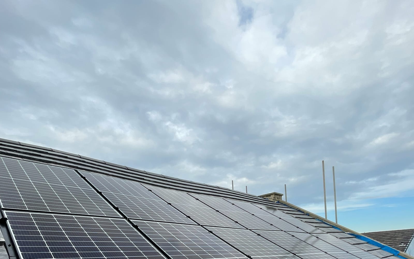 Angled view across a completed commercial rooftop solar array