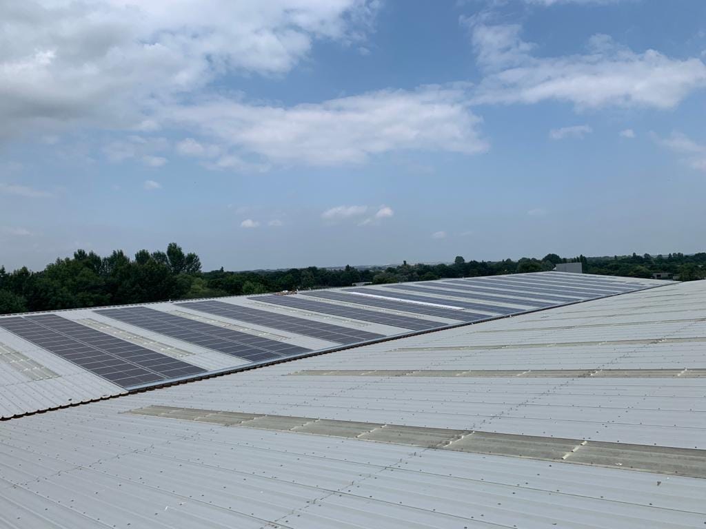 Commercial rooftop solar array across a large North East roof