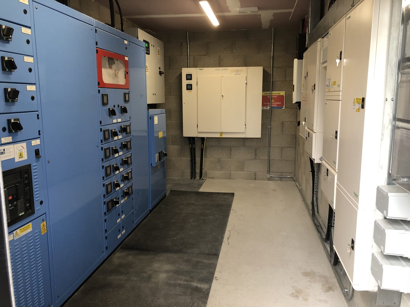 Commercial switchgear room with blue distribution panels, installed and maintained by G Smith Electrical