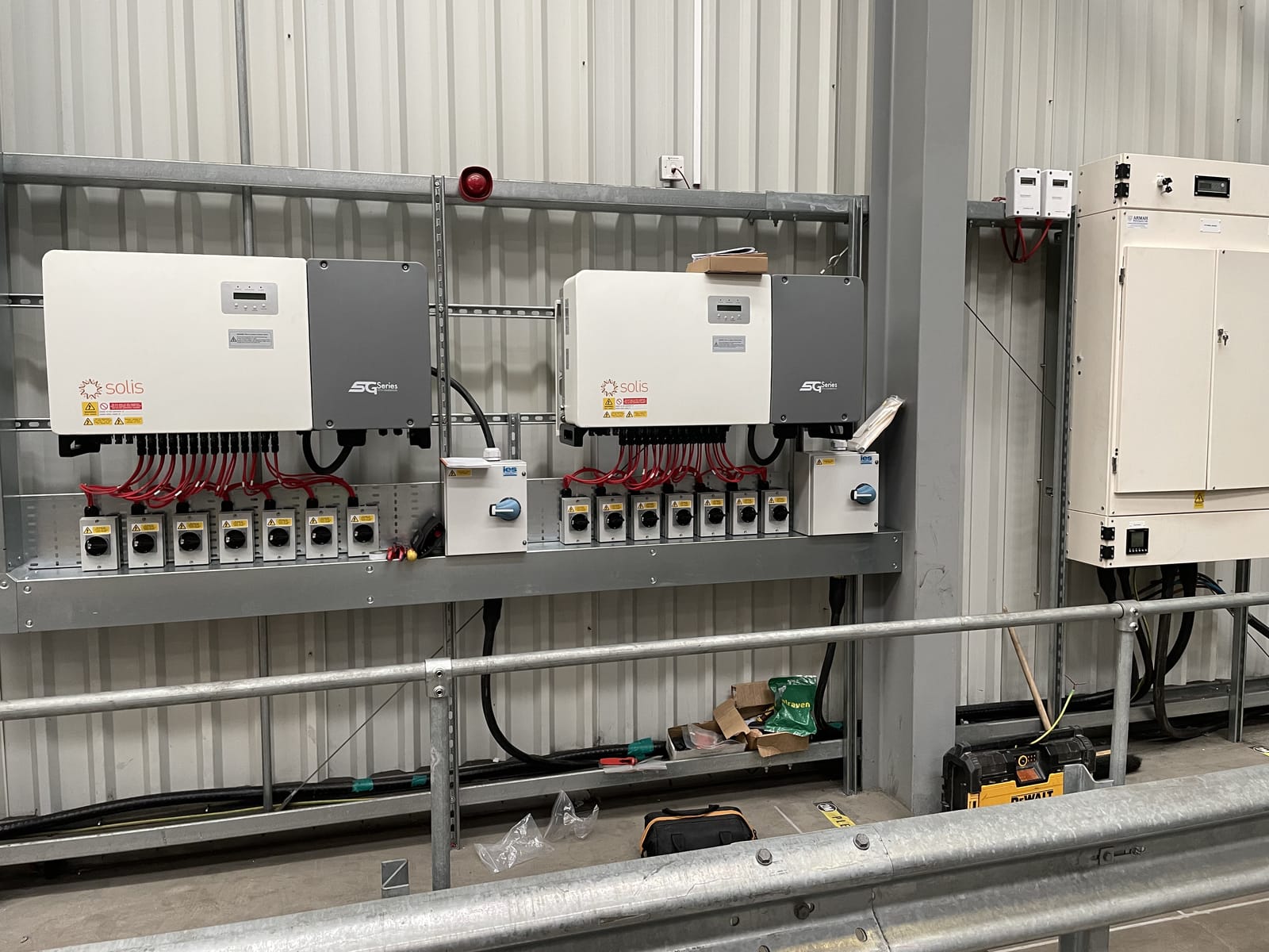 Twin commercial solar inverters beside the distribution board