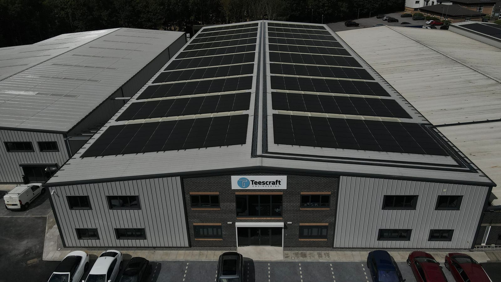 Aerial drone view of a completed rooftop solar array on a commercial warehouse